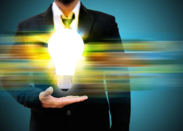 Business man holding light bulb — Stock Photo, Image