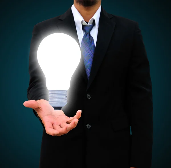 Business man holding light bulb — Stock Photo, Image