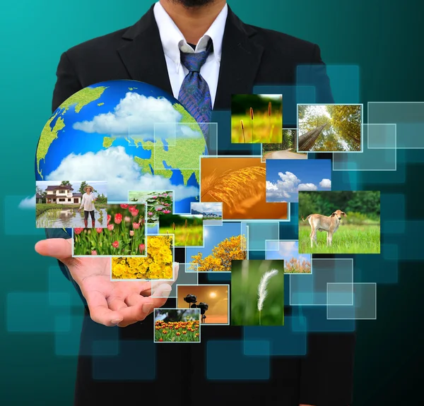 Businessman holding green Earth in hands and Reaching images str — Stock Photo, Image