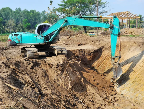 Excavator loader machine with risen boom construction site — Stock Photo, Image