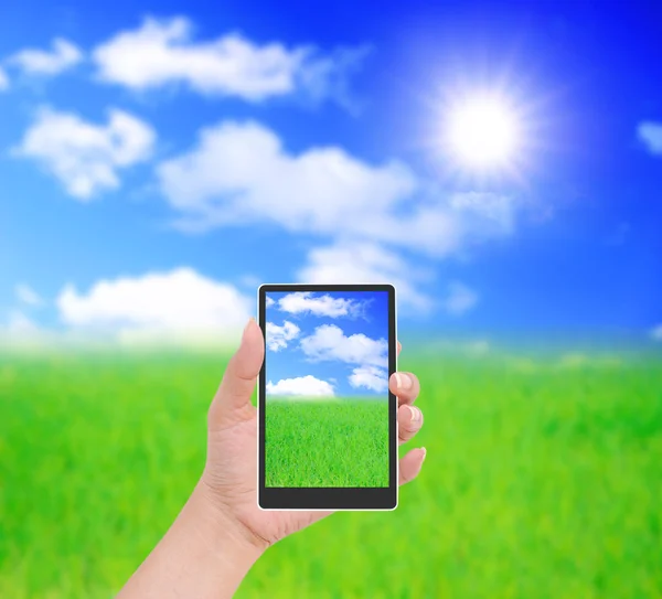 Telefone celular na mão e vista do país do dia ensolarado — Fotografia de Stock