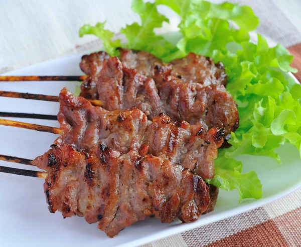 Pork steak with vegetables served on a white plate — Stock Photo, Image