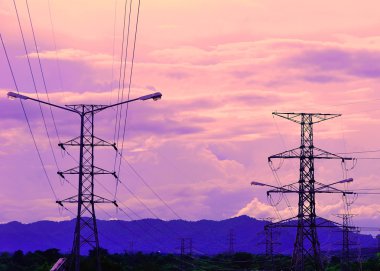 Electricity pylons at sunset clipart