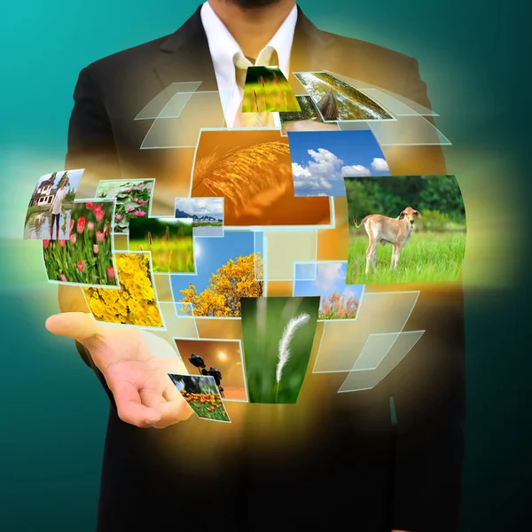 Businessman holding Reaching images streaming in hands — Stock Photo, Image