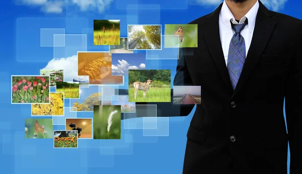 Businessman holding Reaching images streaming in hands — Stock Photo, Image