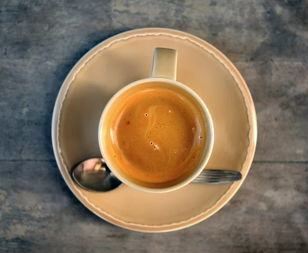 Cup of coffee on a wooden table — Stock Photo, Image