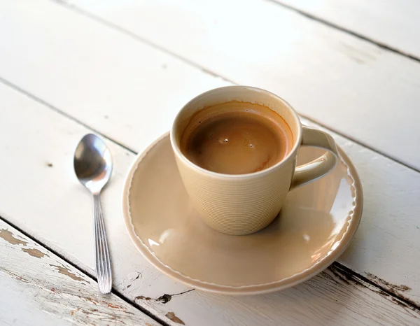 Cup of coffee on a wooden table — Stock Photo, Image