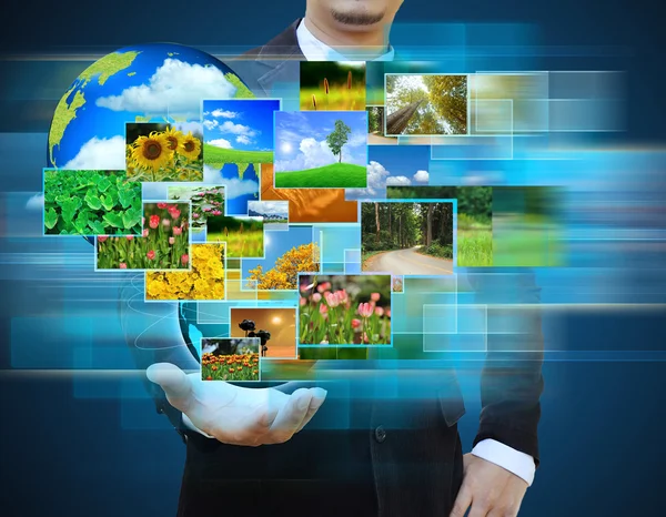 Businessman holding green Earth in hands — Stock Photo, Image