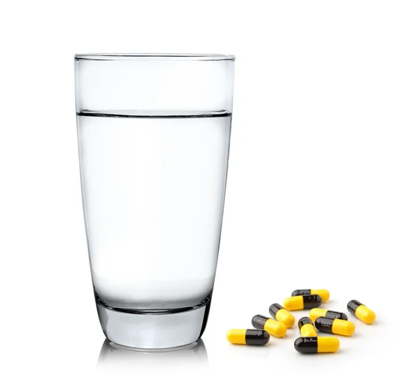 Glass of water and pills isolated on white background — Stock Photo, Image