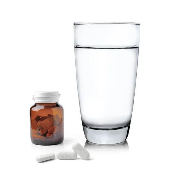 Glass of water Medicine bottle and pills isolated on white backg — Stock Photo, Image