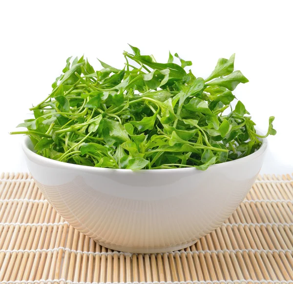 Watercress in bowl on bamboo — Stock Photo, Image
