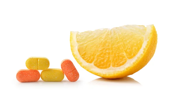 Slice of lemon fruit and vitamin c isolated on white background — Stock Photo, Image