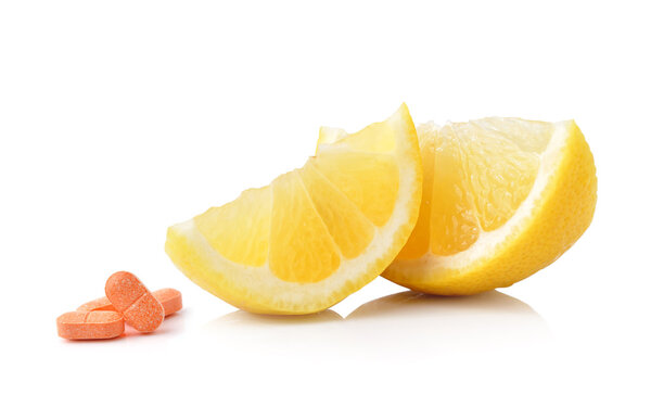 Slice of lemon fruit and vitamin c isolated on white background