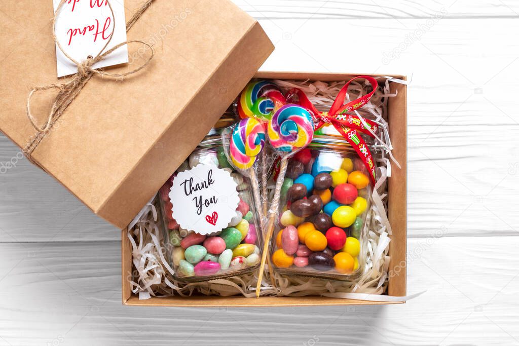 Handmade care package, seasonal gift box with candies, cup on white table Personalized eco friendly basket for family, friends, girl for thanksgiving, xmas, Christmas, mothers, fathers day Flat lay.