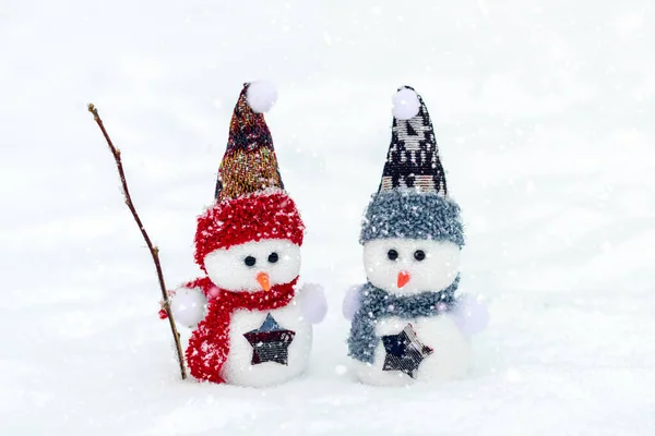 Merry christmas and happy new year greeting card with copy space Happy two little snowmen in red, blue cap and scarf standing in winter snow background Xmas fairytale Hello January, February concept — Stock Photo, Image