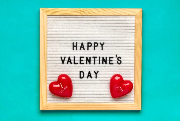 Text Happy Valentines day on felt board, red candles heart shaped on blue background Top view Flat lay Holiday card, love concept — Stockfoto