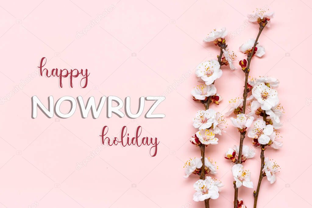 Sprigs of the apricot tree with flowers and Text Happy Nowruz Holiday Concept of spring came Top view Flat lay Hello march, april, may, persian new year.
