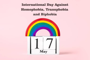 Gökkuşağı LGBT sembolü, Pembe arka planda izole edilmiş takvim 17 Mayıs - Homofobiye Karşı Uluslararası Gün, Ulaşım fobisi ve Biobi tebrik kartı konsepti.