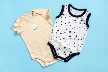 Güzel aksesuarlar - yeni doğan için kıyafetler, mavi arka planda izole edilmiş pamuk fotokopi alanı çocukluk, annelik, moda tekstili ve yeni doğan Top view.