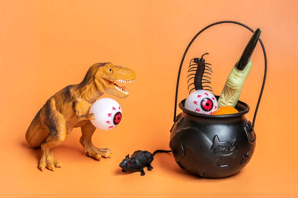 Toy Dinosaur Tyrannosaurus Holding Eye Its Paws Bowl Bat Pumpkin — Stock Photo, Image