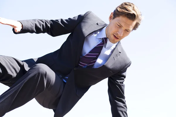 Businessman jumping over something — Stock Photo, Image