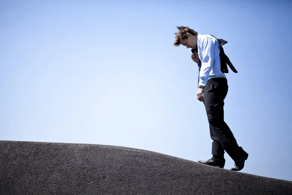 Businessman climbing a holl — Stock Photo, Image