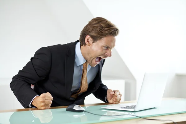 Frustrated businessman shouting at laptop — Stock Photo, Image