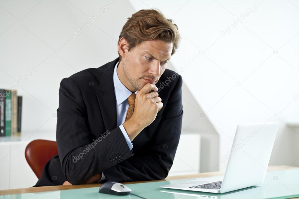 Concerned Businessman in front of laptop