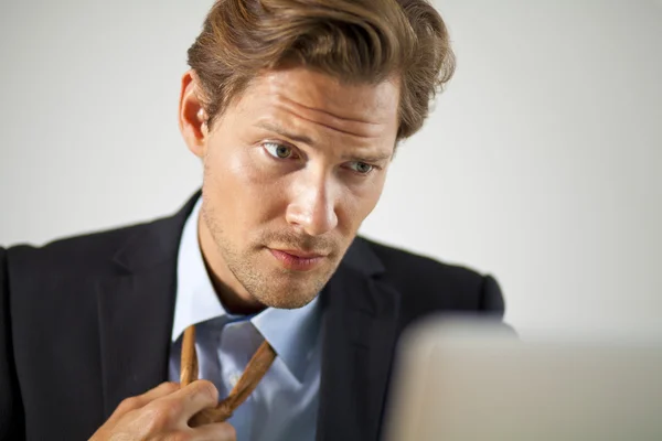 Stressed businessman working on laptop — Stock Photo, Image