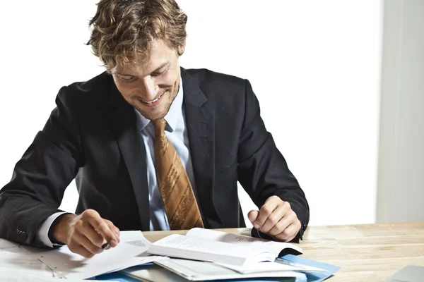 Businessman reading something funny — Stock Photo, Image