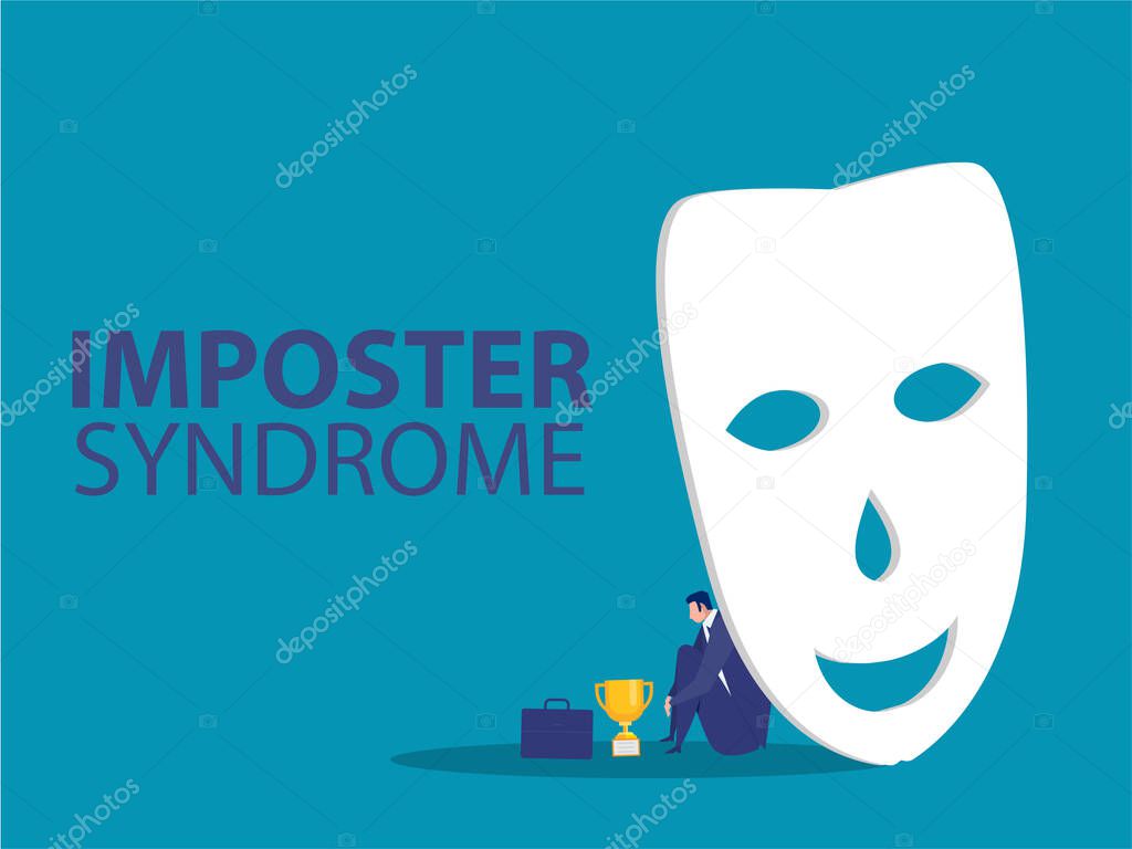 Imposter syndrome.man standing behind mask . Anxiety and lack of self confidence at work; the person fakes is someone else