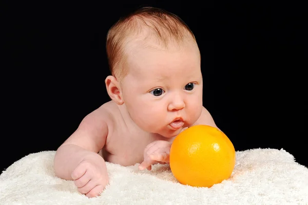 Retrato do belo bebê pequeno com laranja — Fotografia de Stock