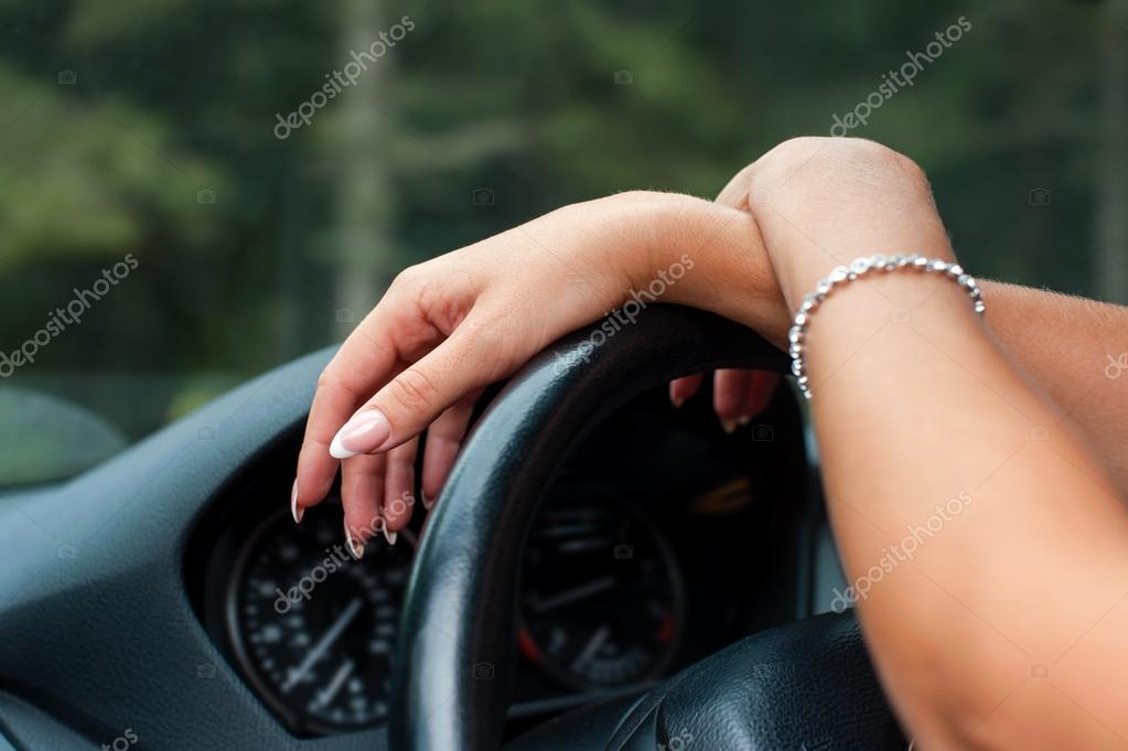 Female hands on steering wheel of a car — Stock Photo © format35 29282987