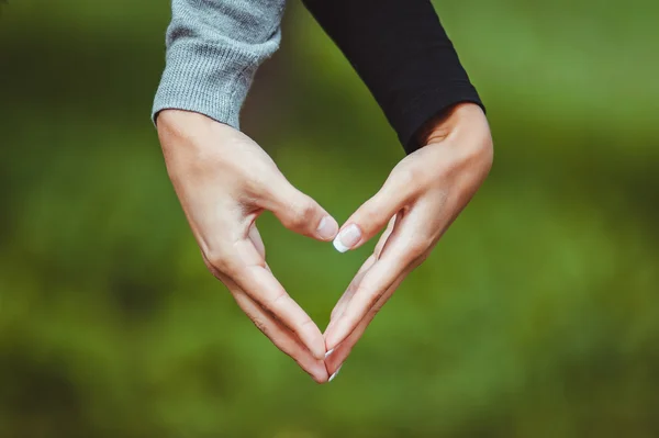 Lovers couple making a heart with hands — Stock Photo, Image