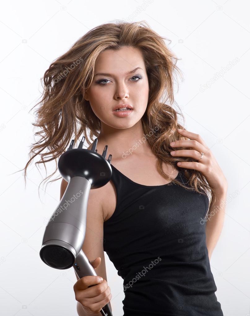 Brunette woman blow-drying long hair