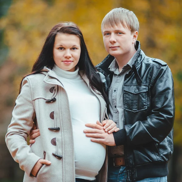 Unga gift gravida par promenader i parken hösten — Stockfoto
