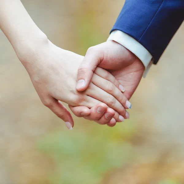 Man and woman holding by hands — Stock Photo, Image