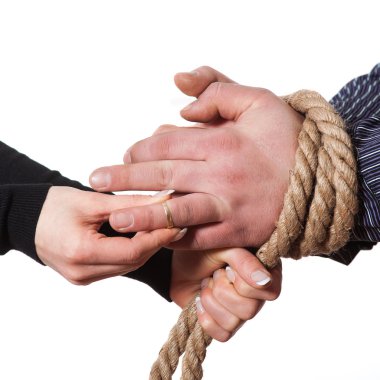 Close up of hands tied with rope