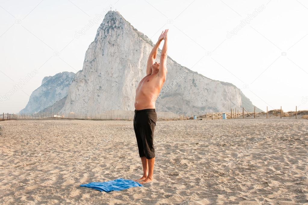 Happy and successful man practicing yoga