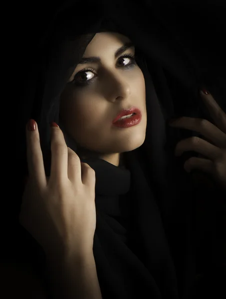 Dramatic portrait of woman with dark hair, red lips, and dark makeup — Stock Photo, Image