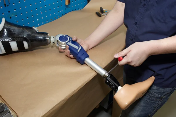 A technician adjusts a prosthetic foot. — Stock Photo, Image