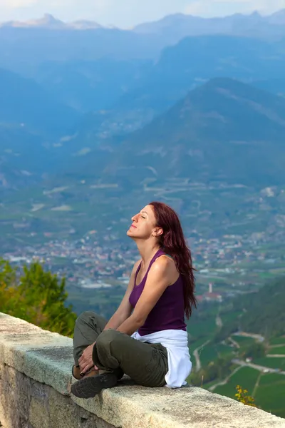 Donna con gli occhi chiusi seduta su un cornicione . — Foto Stock