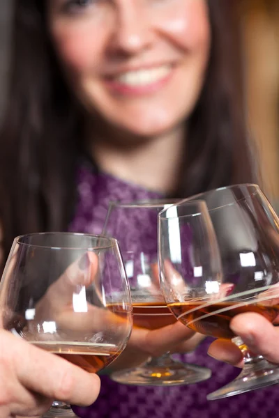 Clinking glasses with fine brandy. — Stock Photo, Image