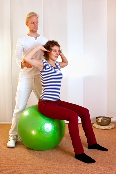 Adult practicing poses on exercise ball — Stock Photo, Image