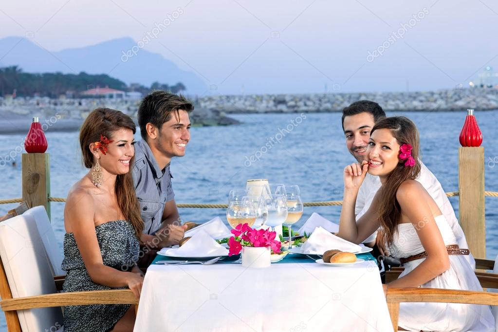 Couples celebrating at a seaside restaurant