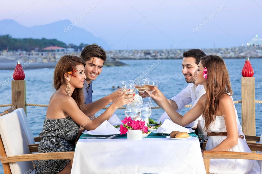 Friends celebrating at a seaside restaurant