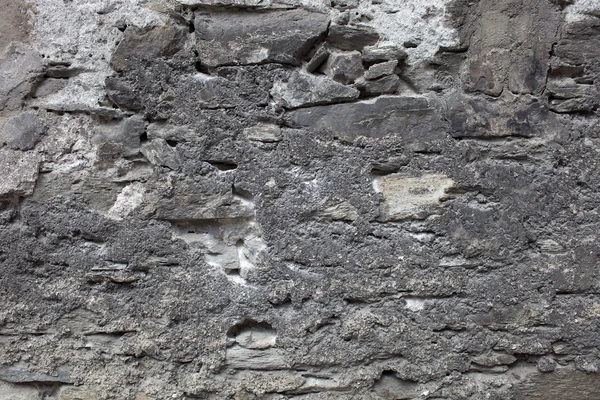 Old plastered stonewall, dark grey. — Stock Photo, Image