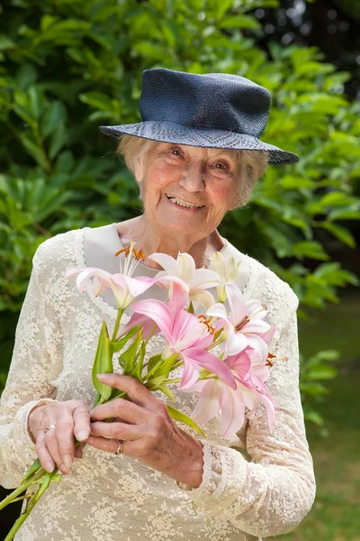 Dame houden van een bos van vers roze lelies — Stockfoto