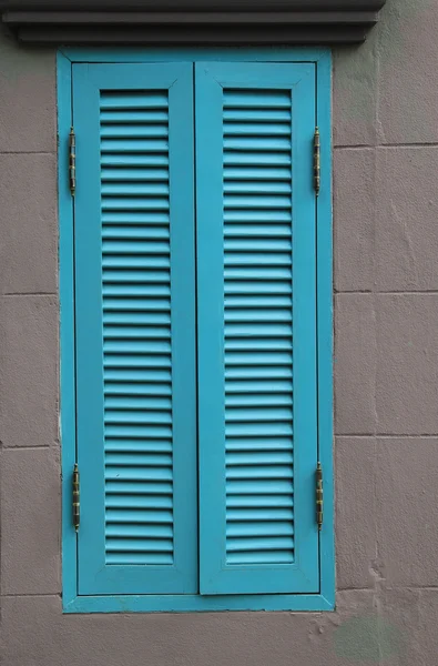 Janela de madeira azul na parede cinza — Fotografia de Stock