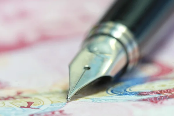 Metal Nib Pen on china money bill — Stock Photo, Image